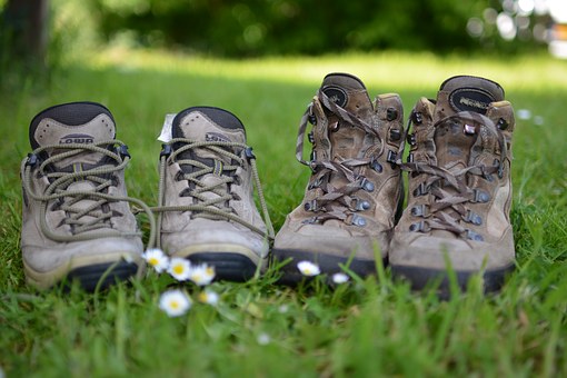 Two pairs of walking boots on grass